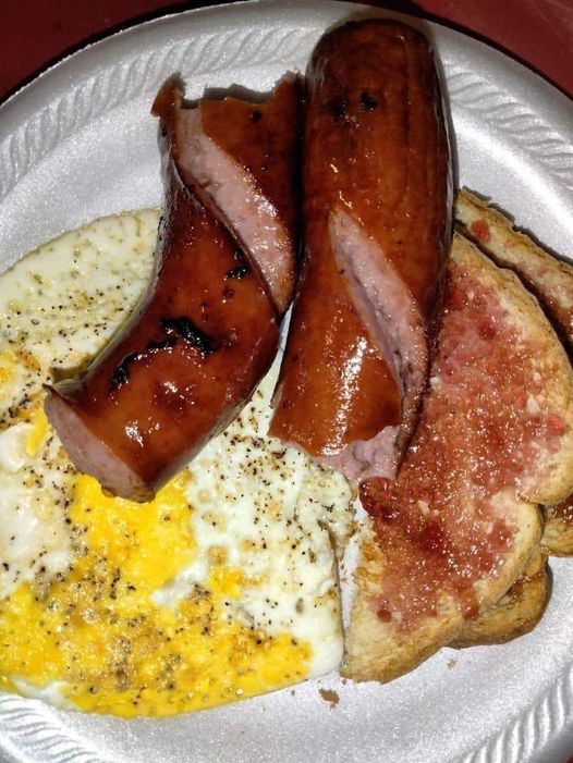 A Delicious Breakfast: Fried Eggs with Bacon, Sausage, and Toast with Jam